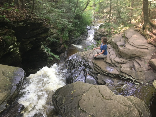 Meditating by waterfall